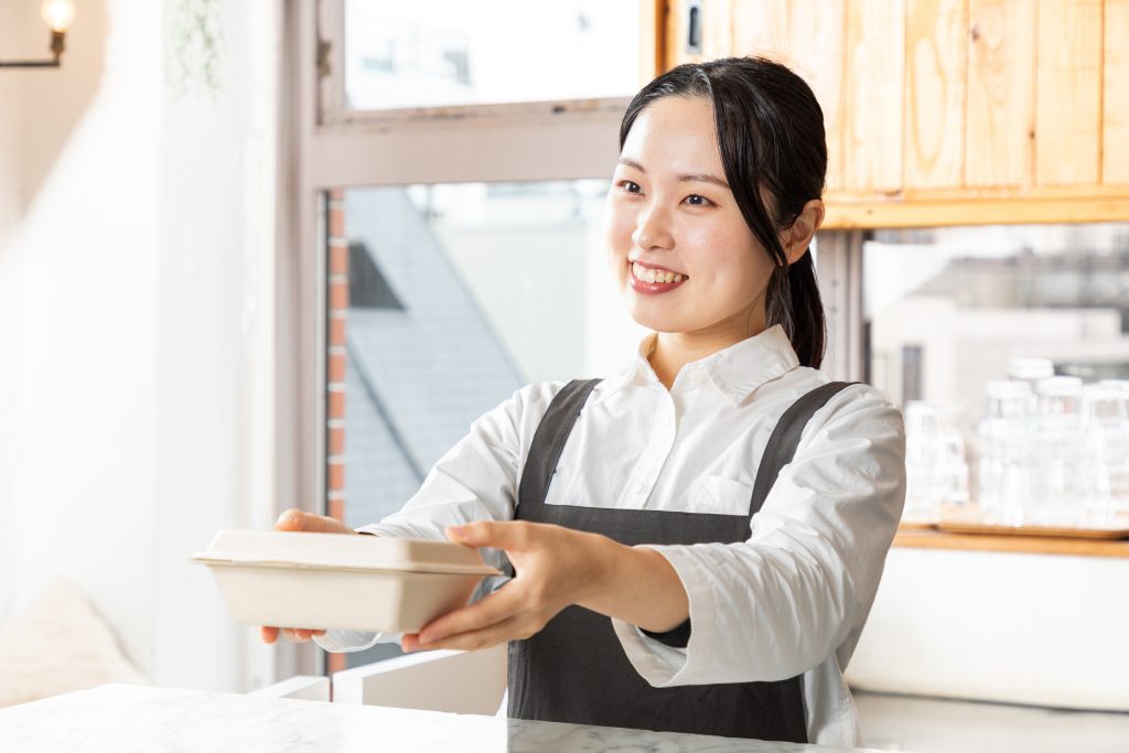 A women shows genuine respect and the right motive in her manner and facial expressions, as she helps a customer and shows real hospitality in service