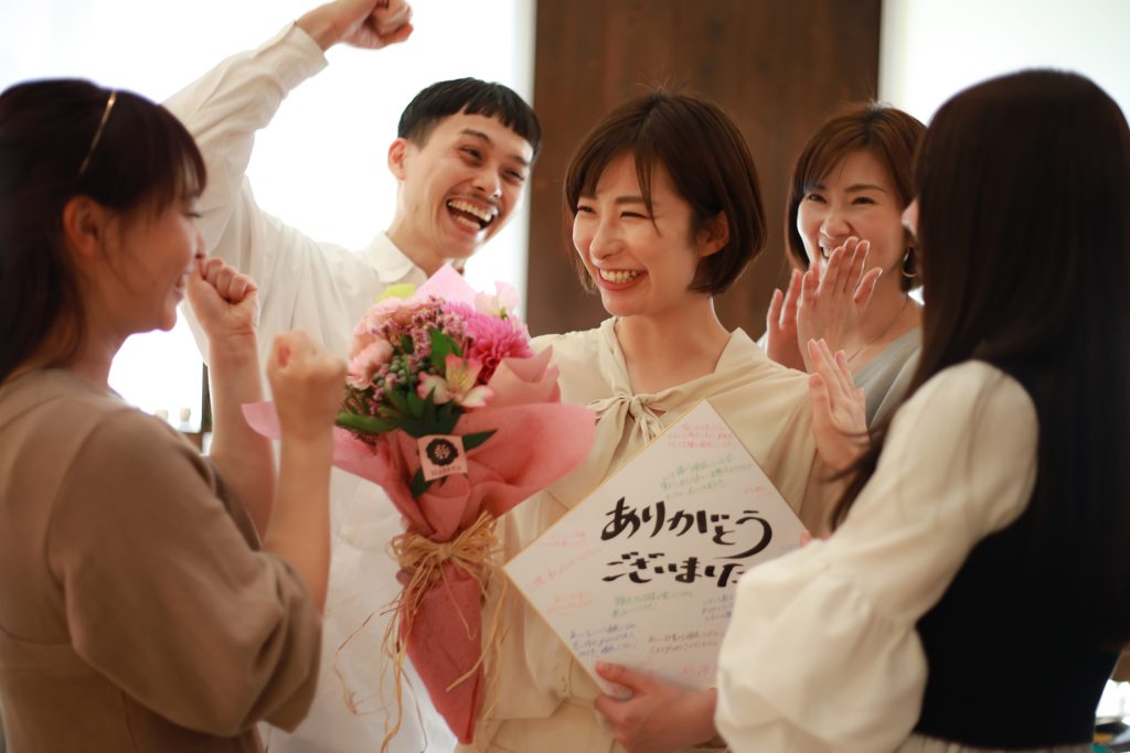 A women receives a thank you and flowers as part of a memorable experience of hospitality, showing that small details matter